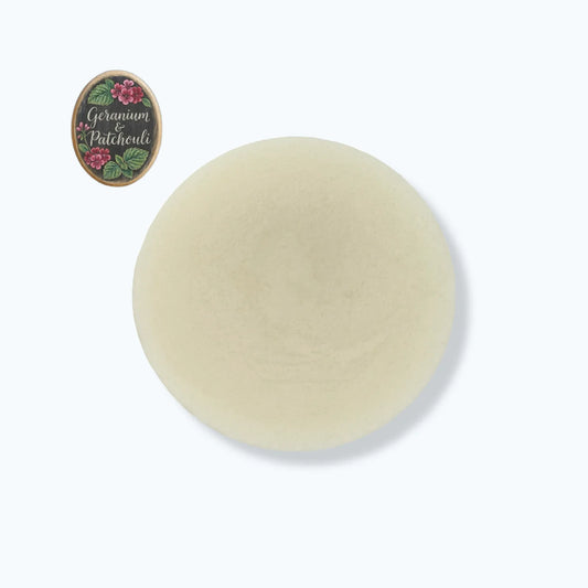 Round beige soap bar with 'Germamia Patchouli' label on a white background