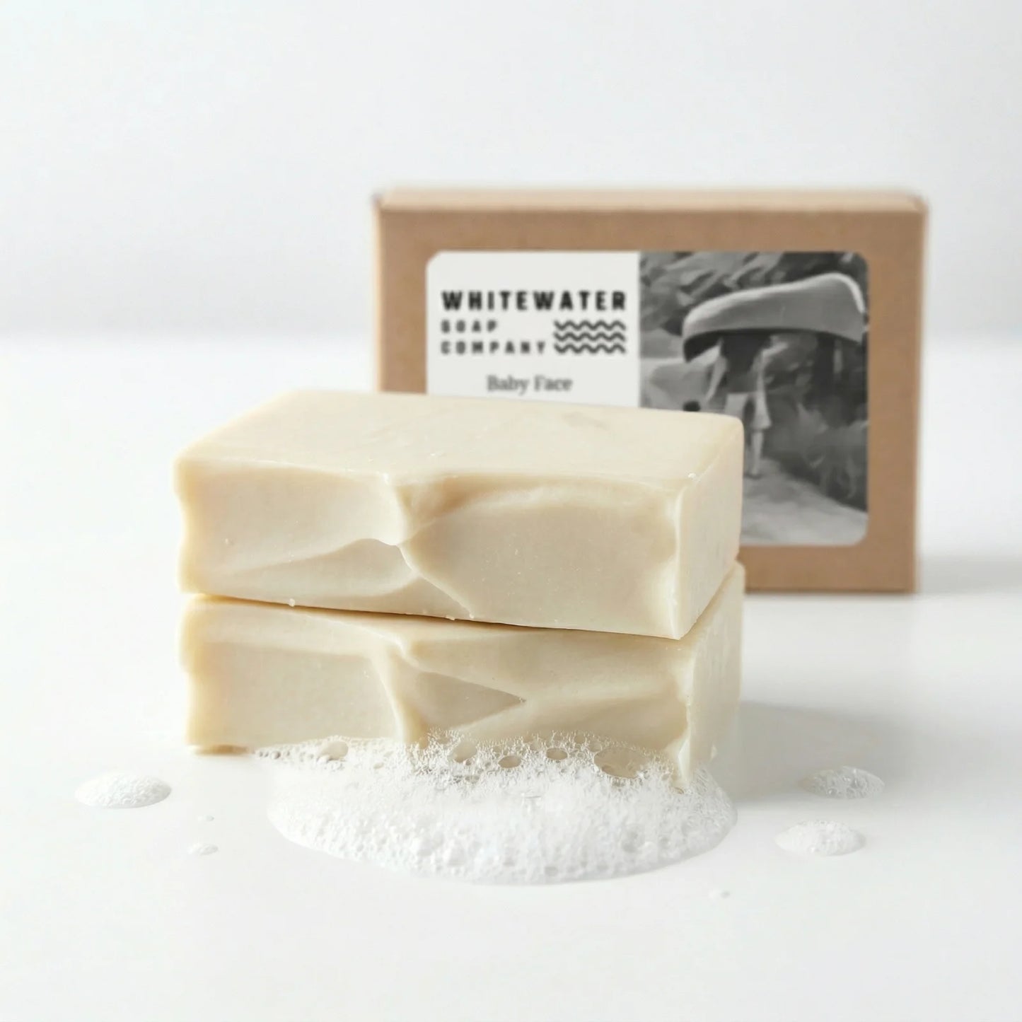 Two bars of soap with a box from Whitewater Soap Company on a white background