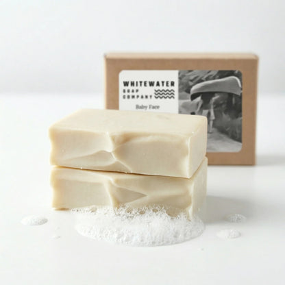 Two bars of soap with a box from Whitewater Soap Company on a white background