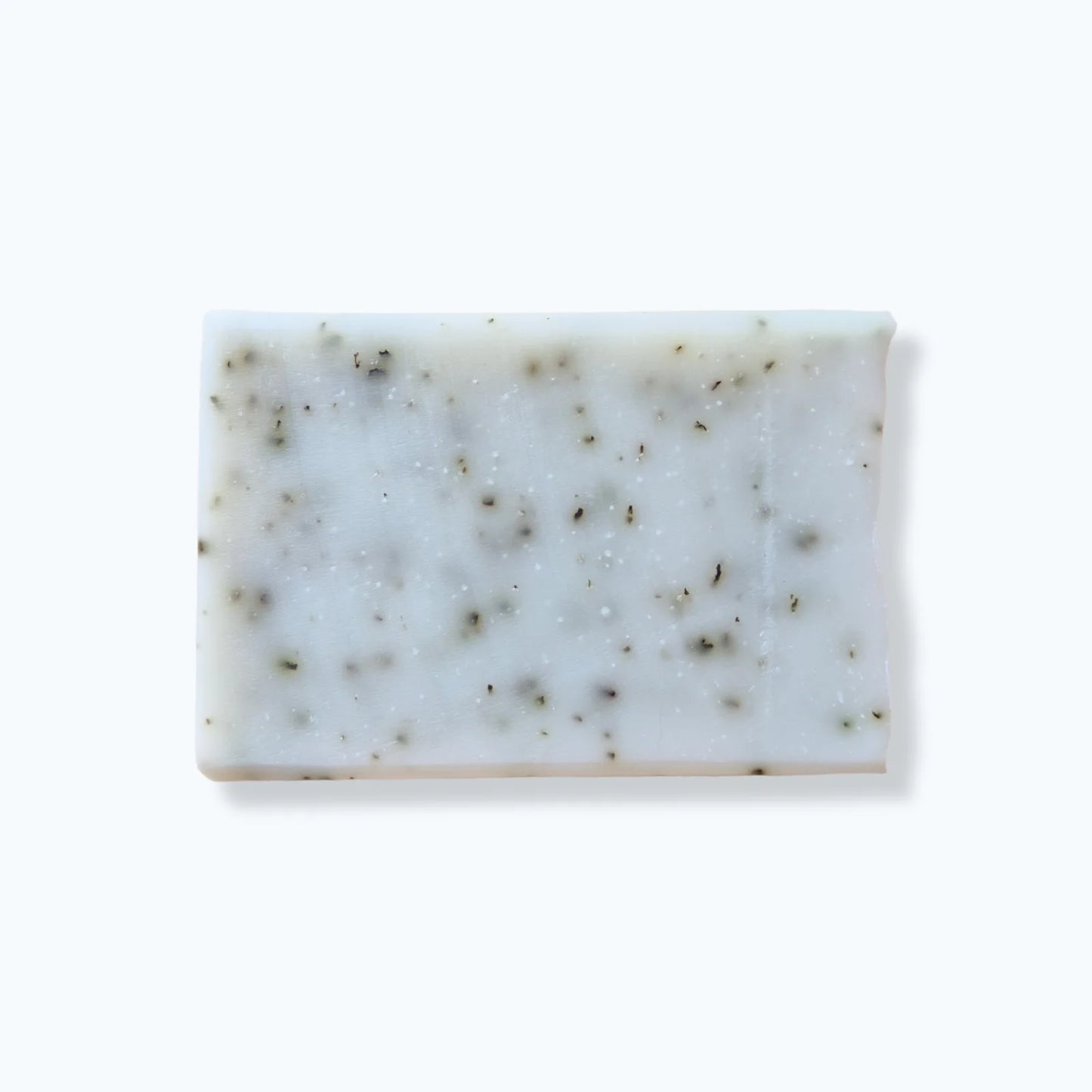 Rectangular bar of soap with specks of peppermint on a white background