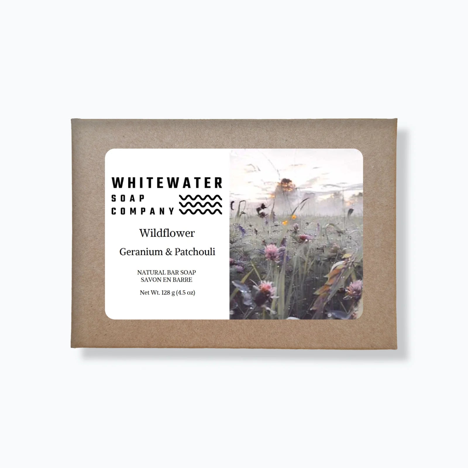 Whitewater Soap Company packaging with a label and image of a person in a field of flowers.