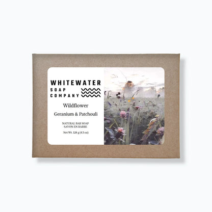 Whitewater Soap Company packaging with a label and image of a person in a field of flowers.