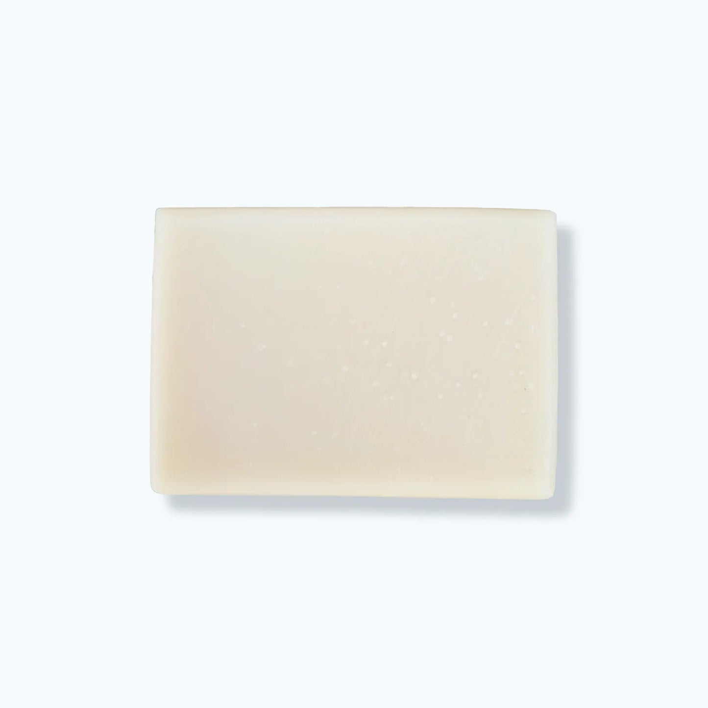 Beige soap bar on a light gray background