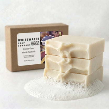 Stack of soap bars with a box labeled 'Whitewater Soap Company' on a white background