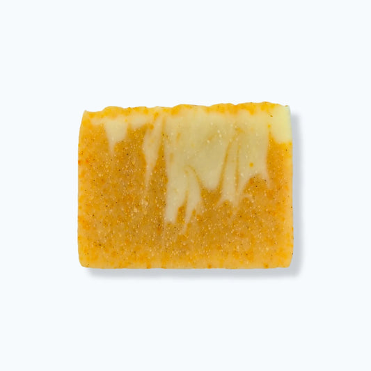 Yellow and white marbled soap bar on a white background