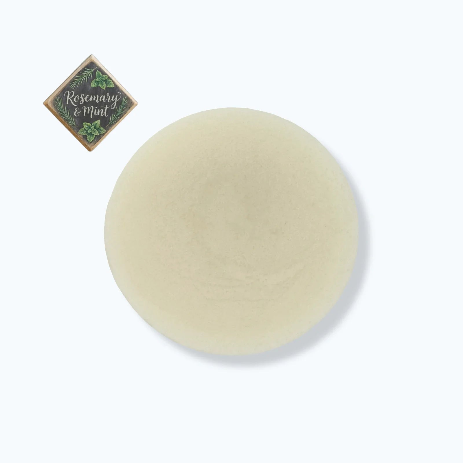 Round beige soap bar with 'Rosemary & Mint' label on a white background