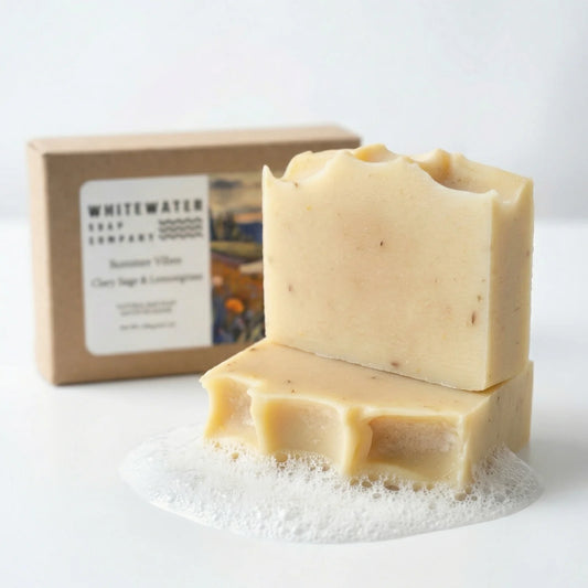 Two bars of soap with a box labeled 'Whitewater Soap Company' on a white background