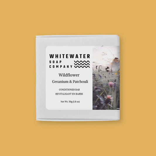 Whitewater Soap Company Wildflower, Geranium & Patchouli conditioner bar  on a yellow background