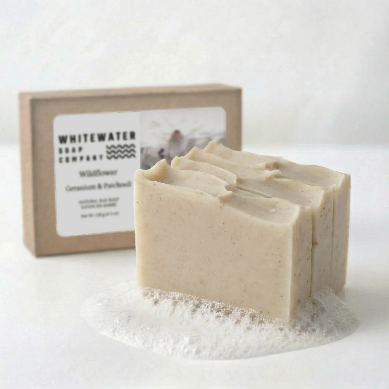 Bar of soap with a box labeled 'Whitewater Soap Company' on a white background